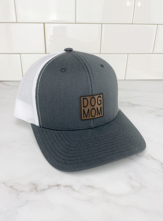 dark grey and white dog mom trucker hat with white mesh back and leather dog mom patch