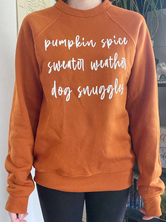 Burnt orange fall favorites Autumn crewneck that reads "pumpkin spice sweater weather dog snuggles"