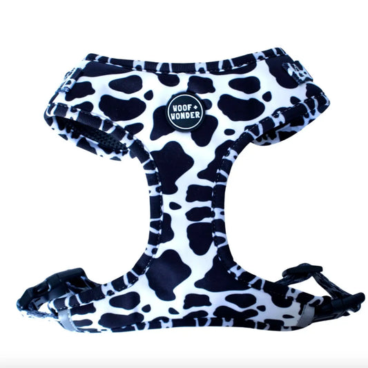 Isolated cow print dog harness with black mesh inside