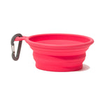 Isolated side view of a red collapsible bowl with a gray carabiner 