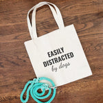 cotton canvas shoulder bag that says "EASILY DISTRACTED by dogs"