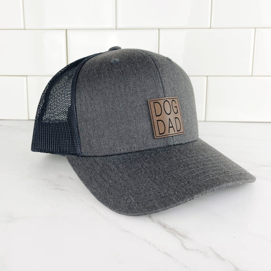 grey dog dad trucker cap with mesh back and a leather dog dad patch