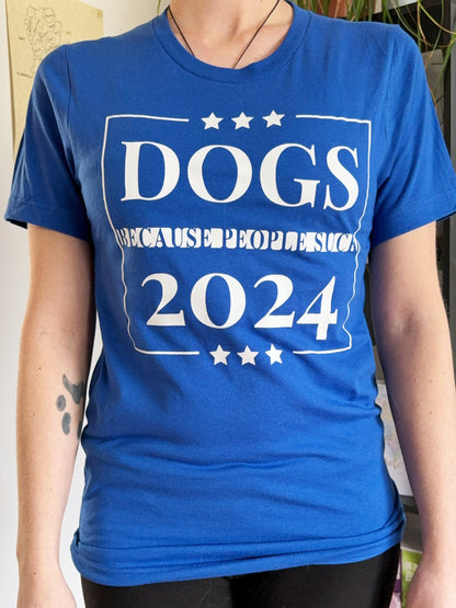 Blue unisex shirt that says "DOGS BECAUSE PEOPLE SUCK 2024"