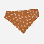 boho rainbow dog bandana made from a light brown fabric with small white rainbows