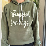 Olive green hoodie with "Thankful for dogs" in white cursive lettering