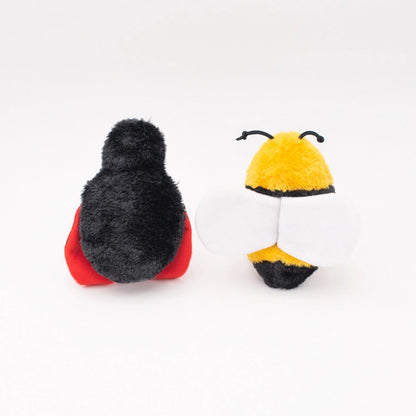 Back view of ladybug and bee plush toys with smiling faces isolated