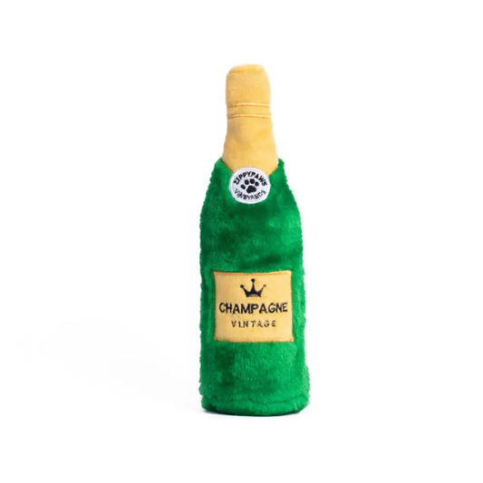 Front view of a plushy green champagne bottle dog toy.