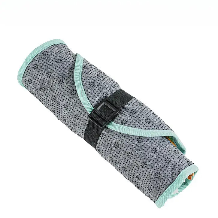 Isolated view of the teal snuffle mat rolled up and secured with a black strap