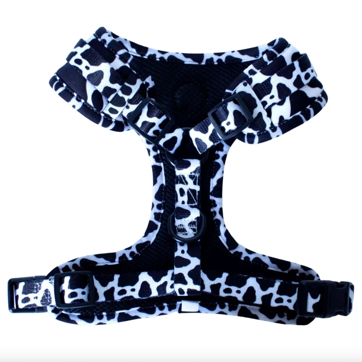Isolated Cow Print dog harness with black mesh on the inside and black hardware
