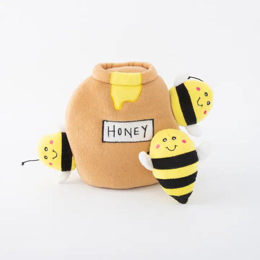 Isolated honey pot burrow toy with three happy plush bees