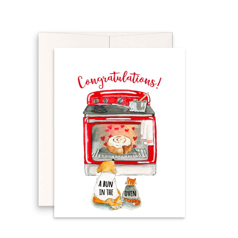 congratulations a bun in the oven card with a picture of an oven with a cinnamon roll baking and a dog and cat watching