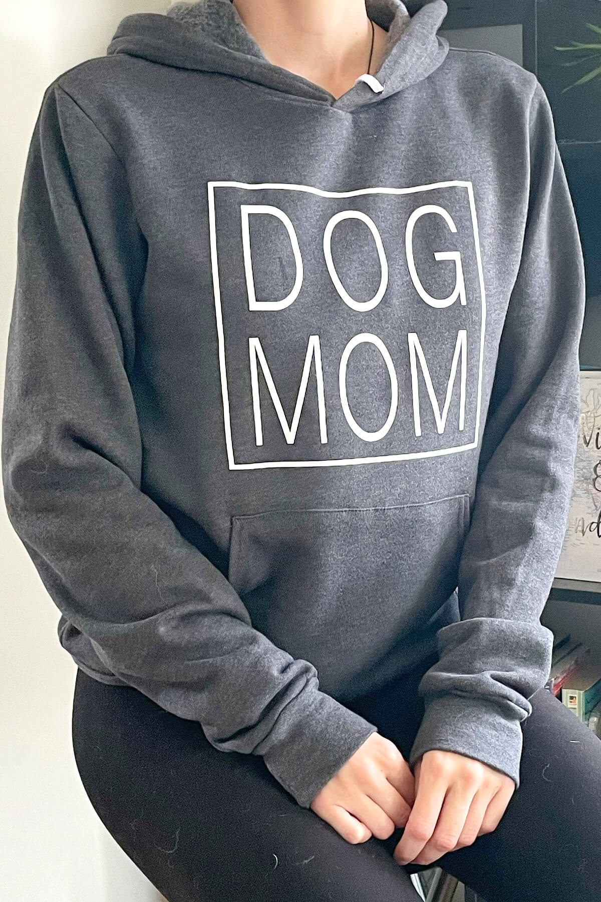 dog mom in all caps in a rectangle on a grey hooded sweatshirt