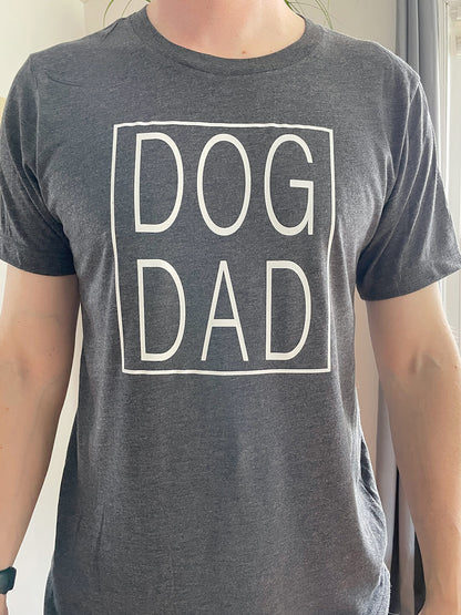 dog dad t-shirt with dog dad written inside a square printed on a dark heather grey shirt with white ink